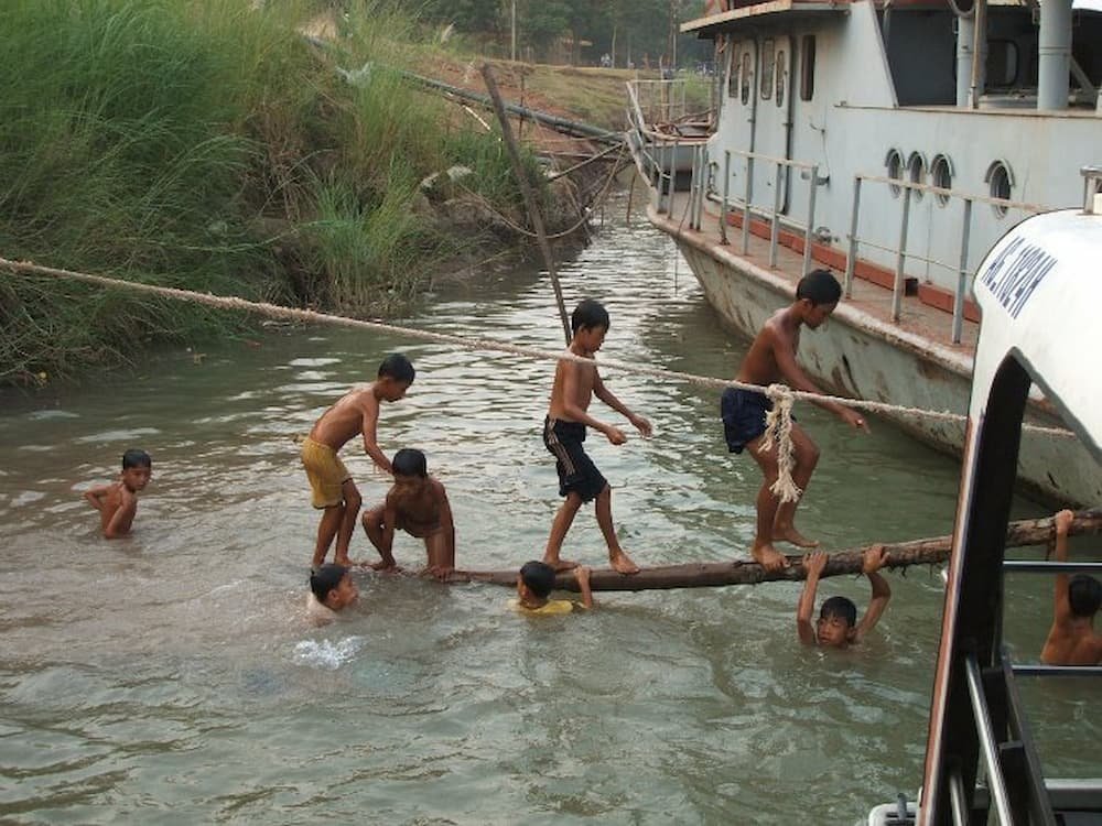 Kids playing by the riverside Kids playing by the riverside